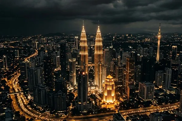 The Kuala Lumpur skyline at night, with the Petronas Towers